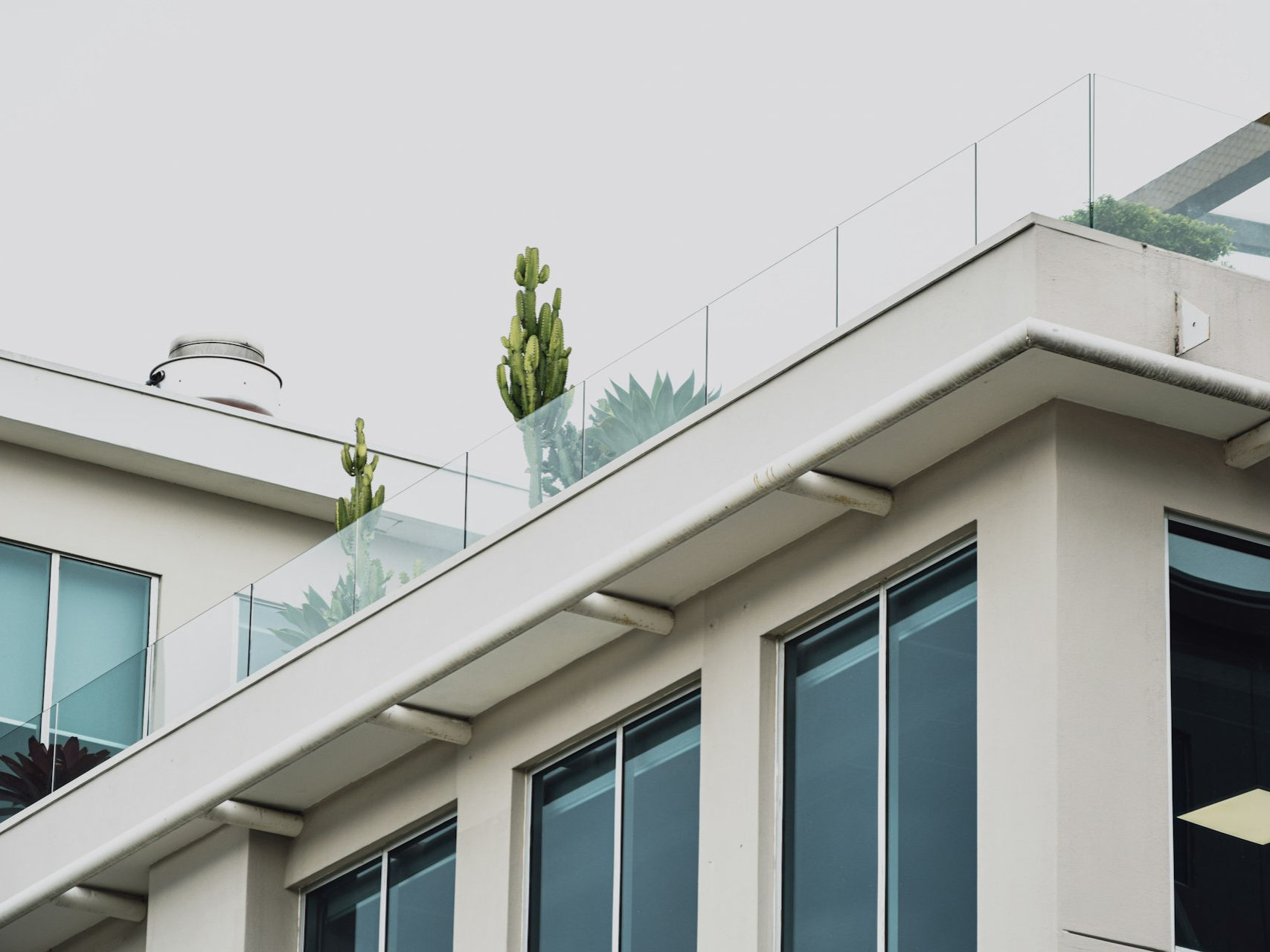 white concrete building with glass windows